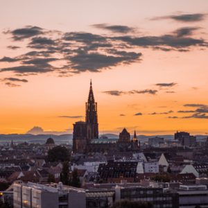 city buildings under orange sky during sunset