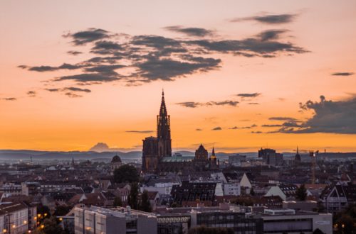 city buildings under orange sky during sunset